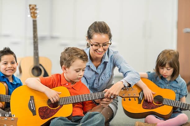 Kids music group plaing guitars